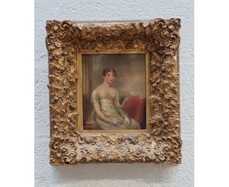 English School, second quarter 19th century, three quarter length portrait of a young lady with a dove, oil on chamfered oak 