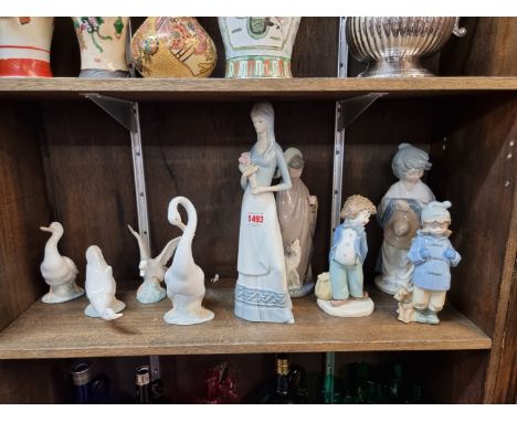 Seven Nao figures,&nbsp;largest 27cm high; together with a Lladro goose; and another continental figure, 33.5cm high. (9) 