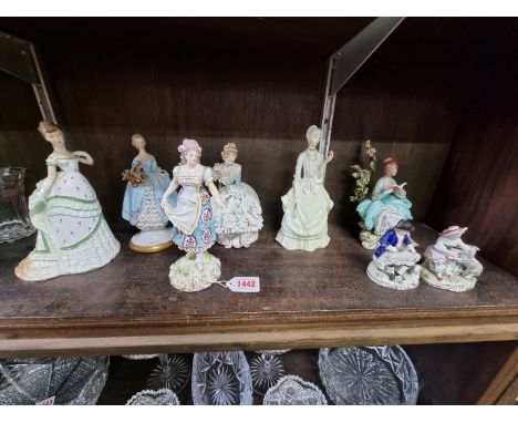 A small group of porcelain figures, to include a 19th century Derby example, 18cm high; two Royal Worcester examples; and a s
