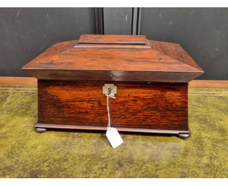 An early Victorian rosewood sarcophagus tea caddy, 37cm wide, (cut glass mixing bowl riveted).&nbsp; 