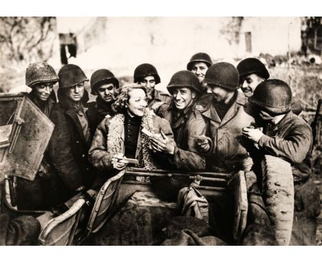 * Dietrich (Marlene, 1901-1992). A large press print showing Marlene Dietrich signing autographs for US soldiers in France, p