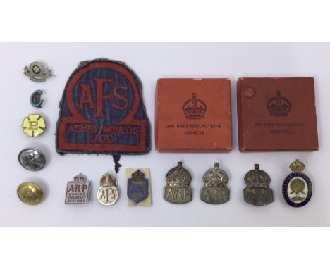 A good selection of WW2 and WW1 British Home Front badges. To include: a scarce wartime era Auxiliary Fire Service cloth badg