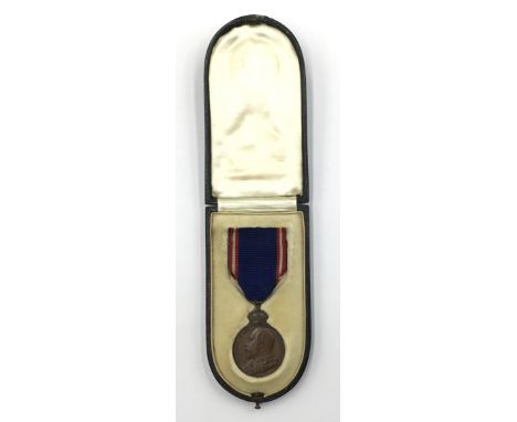 An scarce Edward VII issued Royal Victorian Medal in bronze. Complete with its original ribbon, and dark green leather box wi