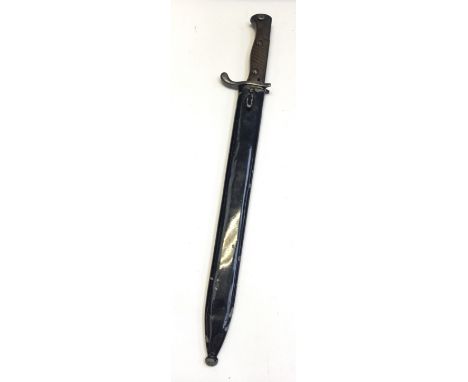 A WW1 era 1915 dated German Mauser butcher’s bayonet. With diagonally ridged wooden slab grips, ‘birds beak’ pommel, and push