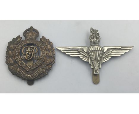 A WW1 era bronze Royal Engineers cap badge with slider to the reverse side, and George V cypher to the centre. Together with 