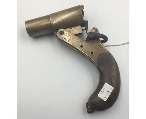 An incomplete WW1 era Webley MKIII 1” Very Cartridge signal pistol in brass with wooden grips and lanyard ring. Marked with ‘