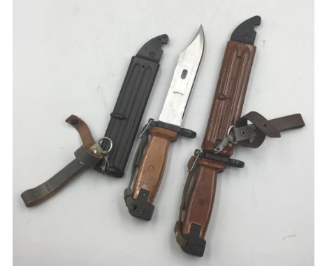 2 examples of the AKM Type II bayonet (AK47). Both with moulded plastic handles, and plastic scabbards with metal wire cutter