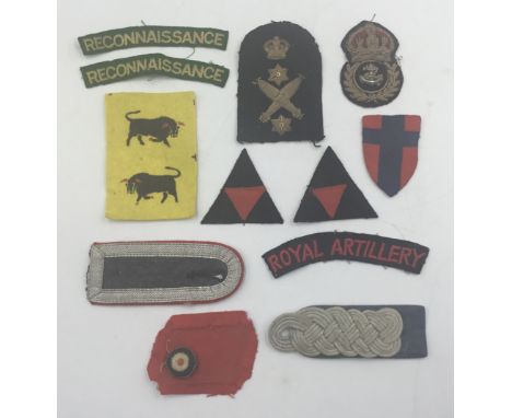 A selection of British and German WW2 era cloth insignia. To include: Royal Navy Petty Officer’s bullion cap insignia, a Roya
