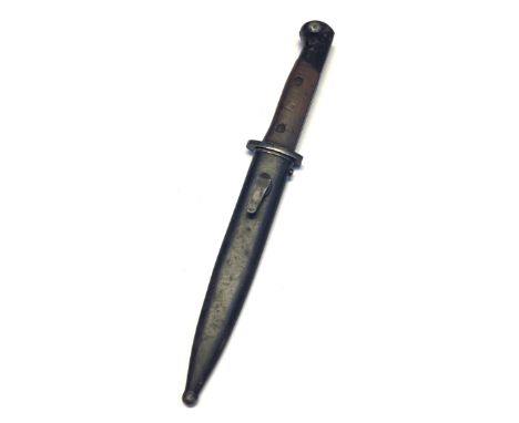 A post WW2 Portuguese M1948 knife bayonet for the FBP Submachine Gun. With wooden slab grips secured by 2 screws. Black paint
