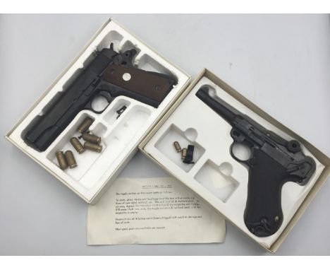 Two inert non-firing replica modern pistols. First, a replica non-firing Luger Parabellum semi-auto pistol marketed by Replic