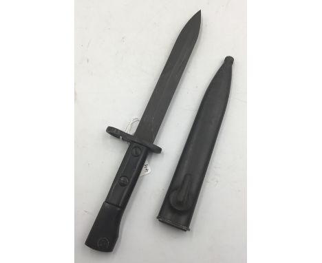 A South African S1 bayonet for the Uzi Submachine gun. With black composite grips, and a parkerised pommel and cross guard, t