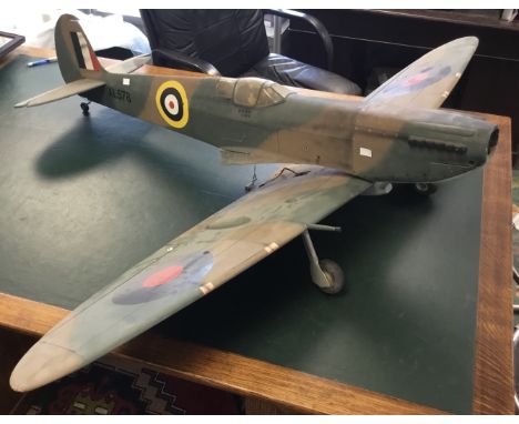 A large, painted balsa wood scale model of a WW2 era Spitfire. Part of the Mick Reeves range of model aircraft. Currently in 