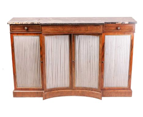 A Regency marble topped figured rosewood four-door breakfront chiffonier, with black veined marble top above three frieze dra