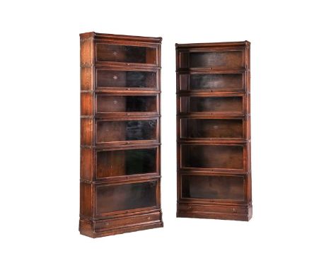 A pair of early 20th century oak Globe Wernicke six-section stacking bookcases, makers labels to the interiors, each 208 cm x