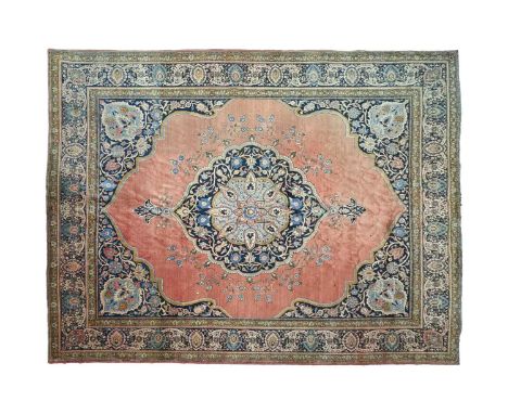 A room size 'Antique' tomato red round Tabriz country house type carpet, first half of the 20th century, of 'Book Cover' desi