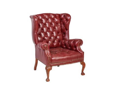 A George III style  deep buttoned hide fireside armchair  with close nailed detail supported on carved cabriole legs, 86 cm w