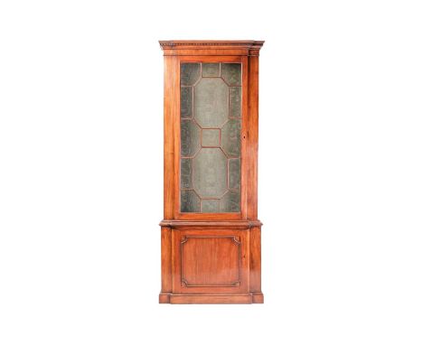 A Victorian narrow pillar bookcase, with an astral glazed door over a single cupboard door, 240 cm x 94 cm x 37 cm.