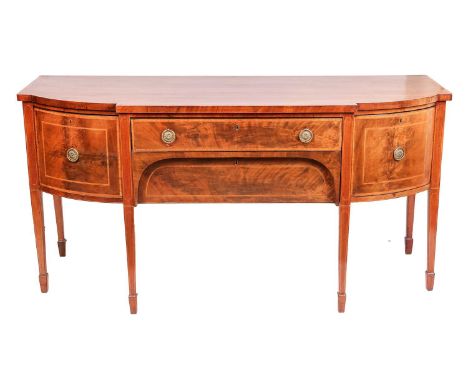 A George III bow break fronted breakfast sideboard with satinwood cross-banded top with a central frieze and kneehole drawer 