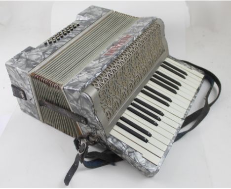 An Alvari piano accordion in mother of pearl effect case.