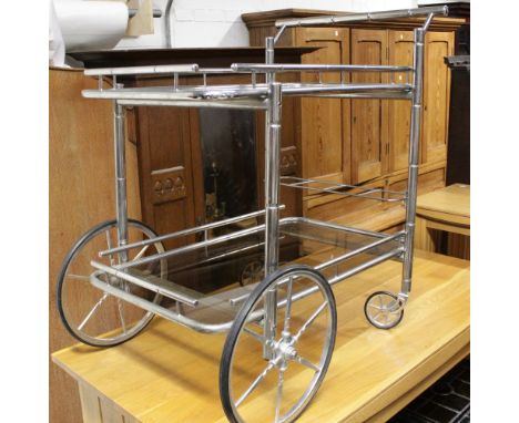 A Heals vintage chrome and smoky glass two-tier drinks trolley with faux bamboo rails and four square decanter shelf. CONDITI