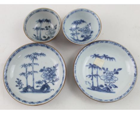 Two Chinese blue and white porcelain tea bowls and saucers decorated with landscape scenes, originally from the Nanking cargo