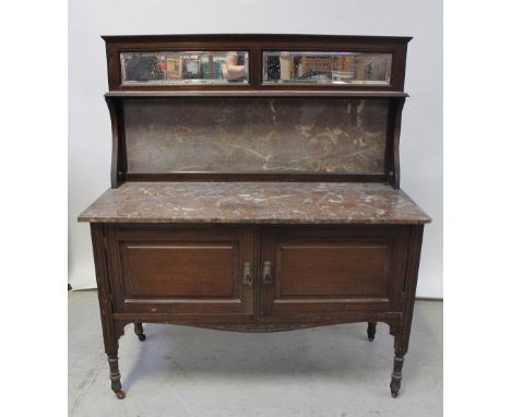 A Victorian rouge marble top wash stand, rectangular mirror above single shelf to marble top over two cupboard doors to turne