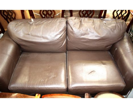 A modern dark brown leather two-seater sofa.