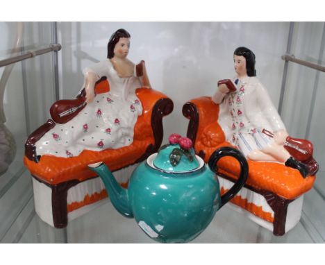 A pair of 19th century Staffordshire figures depicting reclining musicians, a Keel Street Pottery teapot and a foliate motif 