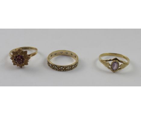 Three 9ct yellow gold rings, one set with chipped diamonds, size Q 1/2, one florally set with red stones, size P 1/2, and the