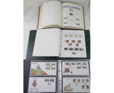 Three albums containing modern stamps on hinged brackets, mostly UK, date range from 1969-2000 and a small collection of Jers