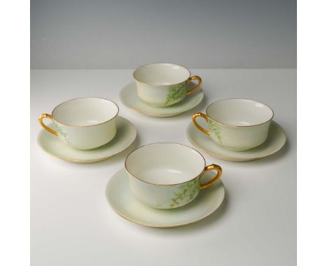 Set of four hand painted porcelain teacups with matching saucers by Haviland France, each featuring a soft green fern pattern