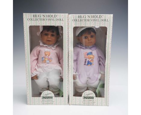 A pair of African American Seymour Mann Hug 'N Hold collector vinyl dolls in their original presentation boxes. These dolls f