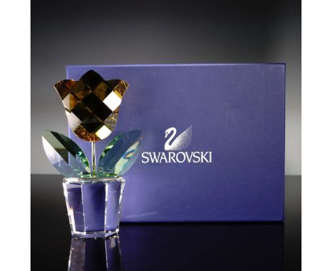 This delightful Swarovski Crystal figurine features a clear faceted pot holding a vibrant yellow tulip with green crystal lea