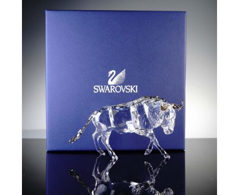 This striking Swarovski crystal figurine depicts a gnu, also known as a wildebeest, in brilliant clear crystal with expertly 