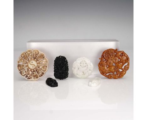 A striking collection of six carved stone pendants in assorted hues and symbolic motifs, each with a hole for hanging. Highli