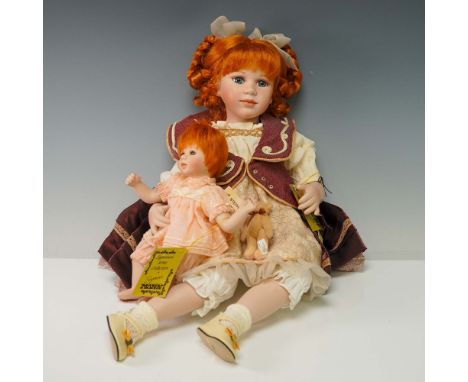 This heartwarming lot features a red-haired porcelain doll named Stephanie from the Seymour Mann Signature Series Collection,
