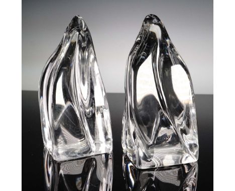 Signed Daum France, this pair of clear crystal bookends features fluid, abstract forms with a modernist aesthetic. Made in Fr