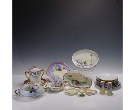 This charming 19-piece collection of hand painted porcelain tableware features a consistent violet floral motif with pastel h