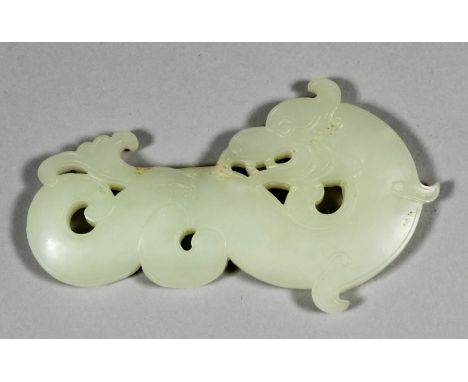 A Chinese white jade pendant carved in the form of a dragon carp in profile, with head turned sharply backwards, 4ins (102mm)