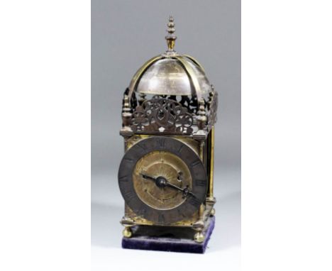 A 19th Century brass "Lantern" style mantel clock, the 6.25ins narrow chapter ring with Roman numerals, the dial centre engra