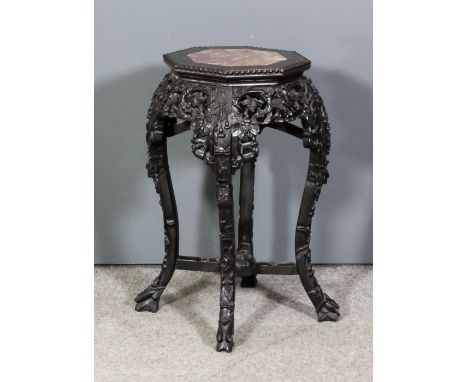 A Chinese rosewood octagonal jardiniere stand, the top inset with pink veined marble panel, the aprons boldly fretted and car