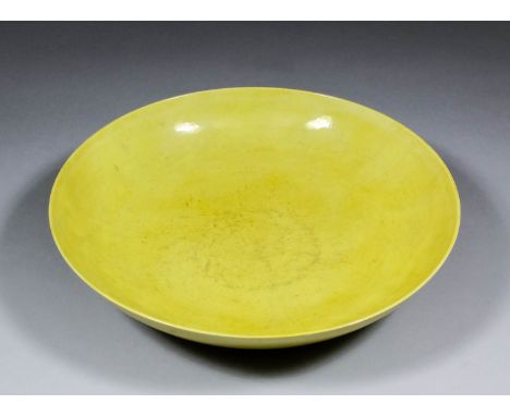 A Chinese yellow glazed porcelain circular saucer shaped dish, 13ins (330mm) diameter x 2.875ins (73mm) high (Kangxi period -