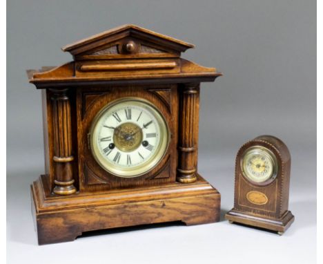 A late 19th Century German oak cased mantel clock, the 4.25ins diameter cream enamelled chapter ring with Roman numerals to t