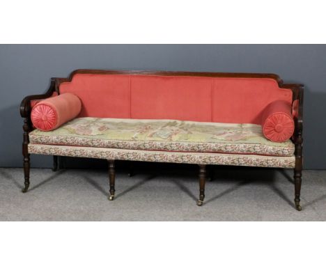 A late George III mahogany framed three seat settee with reeded framing and scroll front arms, on eight turned legs and casto