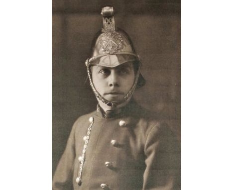 A late 19th/ early 20th Century brass "Merryweather" pattern fireman's helmet, with standard embossed brass badge of two cros