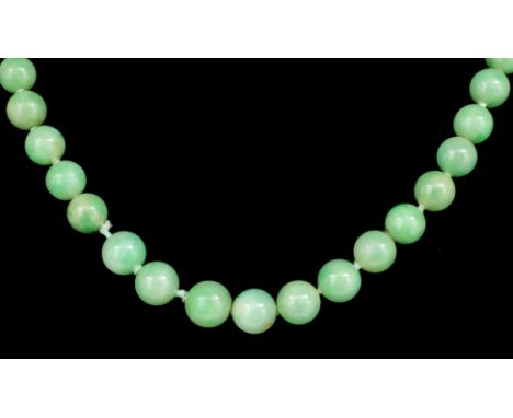 A single strand of graduated jade beads, ranging from 9mm to 4mm diameter, 790mm overall, with an oval gold coloured metal cl