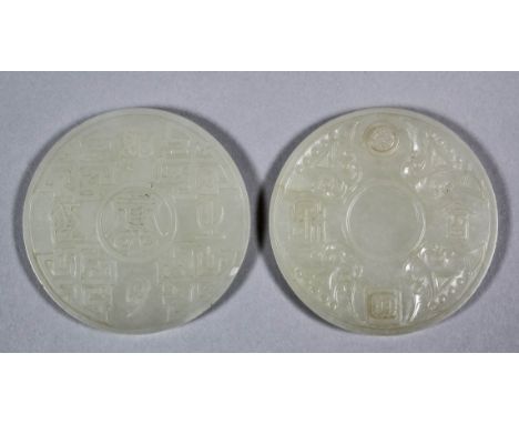 A Chinese pale celadon jade double circular nesting disc, the exterior and interior each finely carved with mythical beasts a