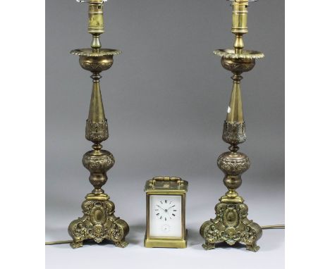 A pair of brass electric table lamps of 18th Century Continental pricket candlestick form on triangular bases, 20ins high, an