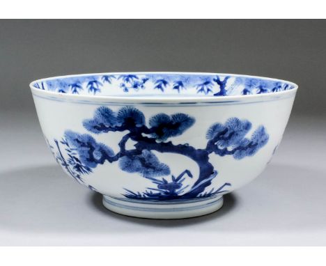 A Chinese blue and white porcelain bowl, the exterior painted with prunus, bamboo and fir trees, the interior with fir tree w