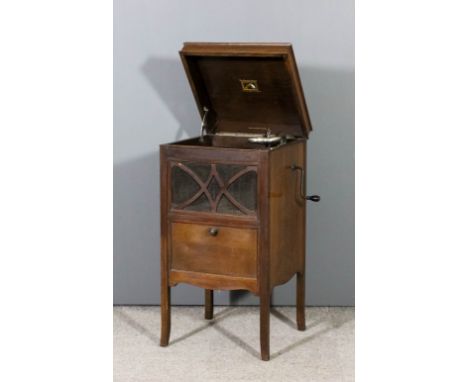 A H.M.V. oak cased gramophone with fretted and mesh speaker, panelled fall-front under, on square tapered legs with splayed t
